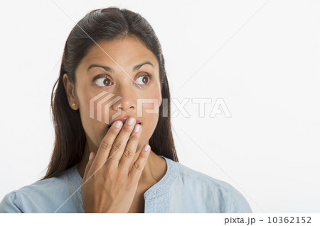 Studio shot of woman covering mouth with hand 10362152