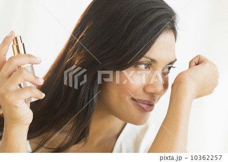 Woman smelling perfume on wrist Woman smelling perfume on wrist 10362257