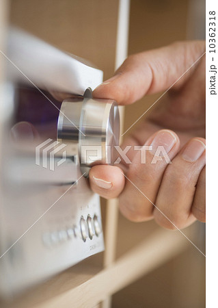 Close-up of hand adjusting audio system 10362318