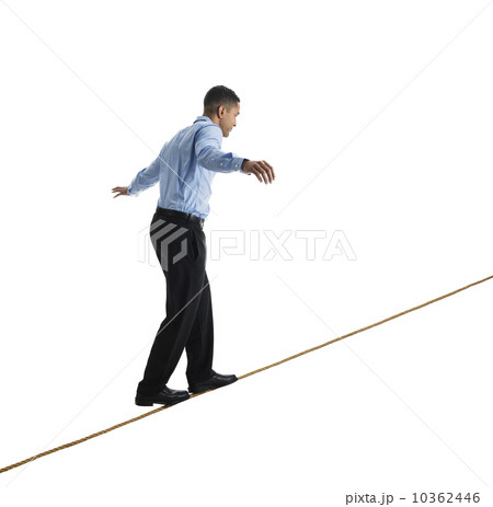 Man balancing on tightrope, studio shot Man balancing on tightrope, studio shot 10362446