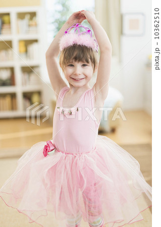 Girl (4-5) wearing tutu dancing in living room Girl (4-5) wearing tutu dancing in living room 10362510