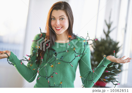 Portrait of woman tangled in Christmas lights 10362651