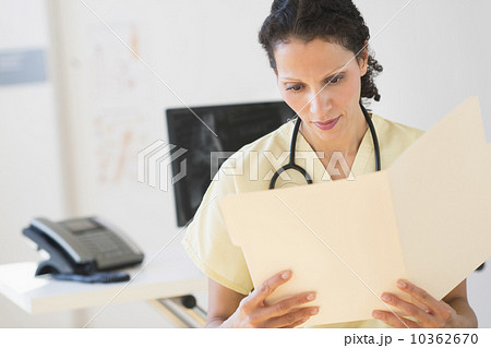 Portrait of doctor reading documents Portrait of doctor reading documents 10362670