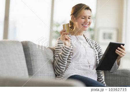 Woman holding tablet pc and credit card 10362735