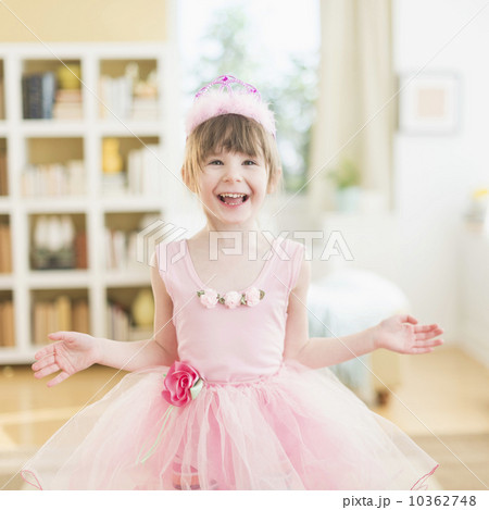 Girl (4-5) wearing tutu dancing in living room Girl (4-5) wearing tutu dancing in living room 10362748