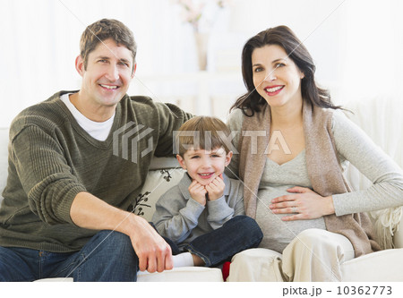Portrait of parents with son (4-5) on sofa 10362773