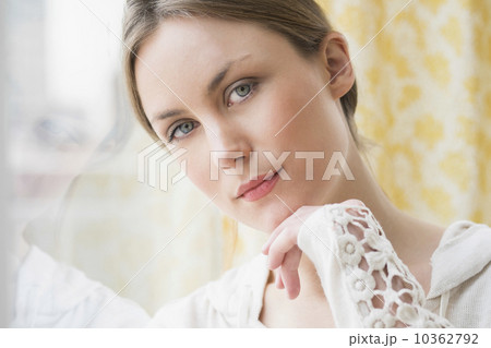 Portrait of young woman by window 10362792