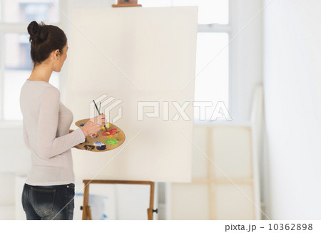 Woman painting at easel 10362898