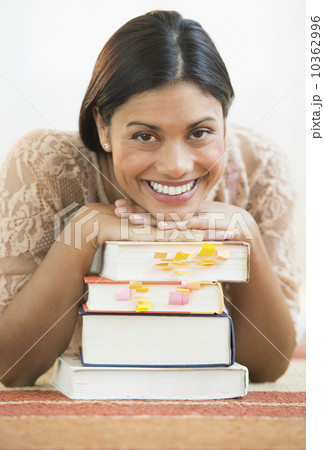 Portrait of female student leaning on books 10362996