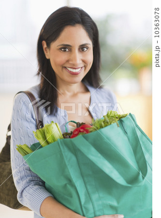 Woman holding bag of fresh vegetables 10363078