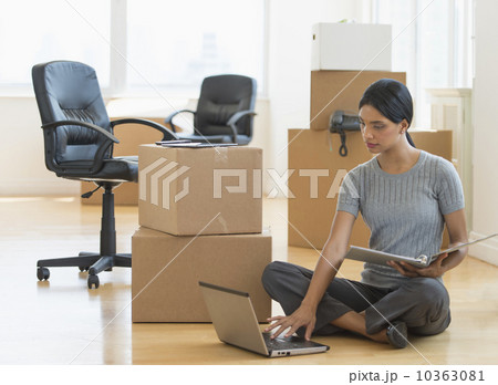 Businesswoman using laptop in new office 10363081