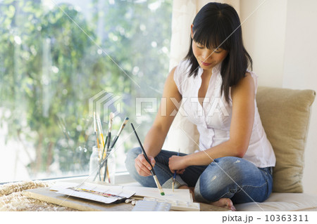 Mid adult woman painting at home 10363311
