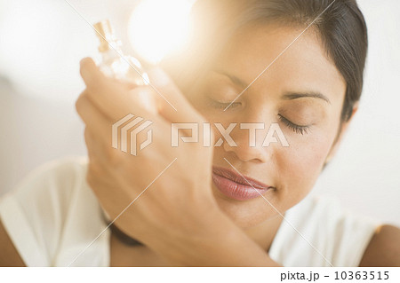 Woman smelling perfume on wrist Woman smelling perfume on wrist 10363515