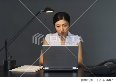 Businesswoman working on laptop at night 10363607