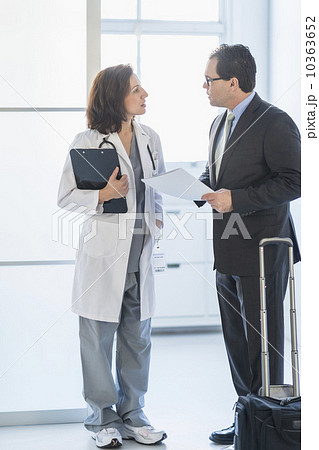 Pharmaceutical representative talking to female doctor 10363652