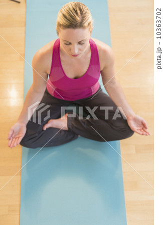 Woman exercising on mat 10363702
