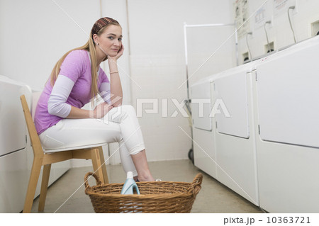 Woman waiting in laundromat 10363721