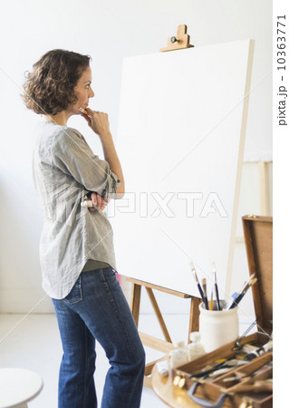 Artist standing in front of canvas 10363771