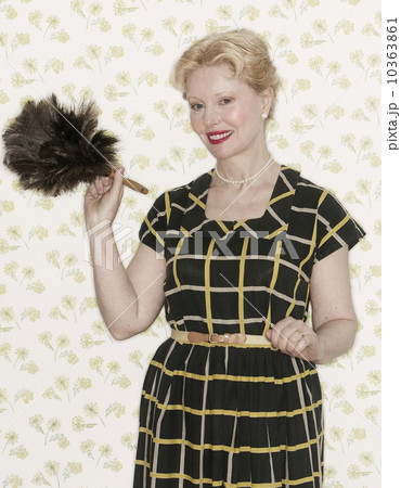 Woman holding a feather duster 10363861