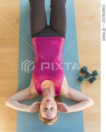 Woman exercising on mat 10363863