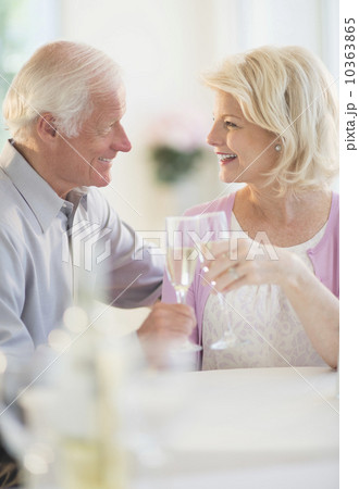 Couple enjoying champagne restaurant 10363865