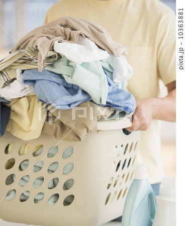 Man carrying laundry basket Man carrying laundry basket 10363881