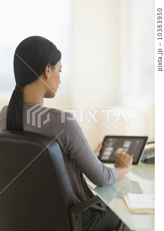 Businesswoman using digital tablet in office 10363950