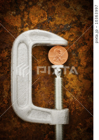 Studio shot of coin in vise grip Studio shot of coin in vise grip 10363997