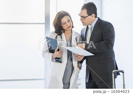 Pharmaceutical representative talking to female doctor Pharmaceutical representative talking to female doctor 10364025