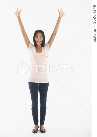 Portrait of woman with arms up, studio shot Portrait of woman with arms up, studio shot 10364349