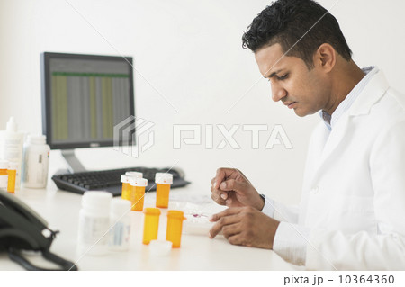 Pharmacist preparing prescription medicine Pharmacist preparing prescription medicine 10364360