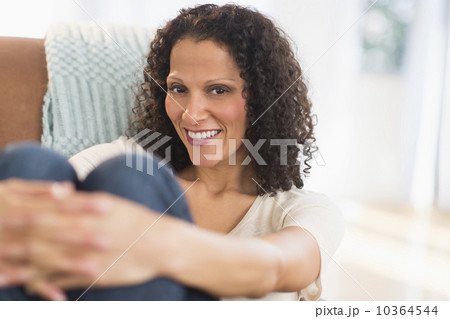 Portrait of woman sitting in living room Portrait of woman sitting in living room 10364544