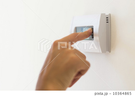 Young woman setting air conditioning Young woman setting air conditioning 10364865