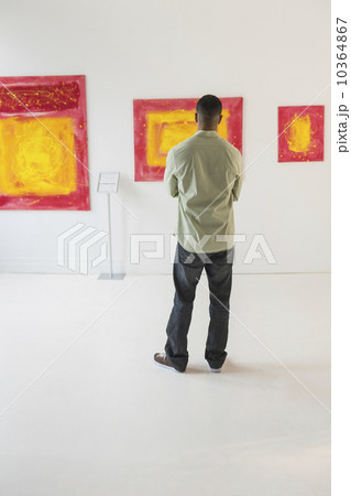 Man watching paintings in modern art gallery Man watching paintings in modern art gallery 10364867