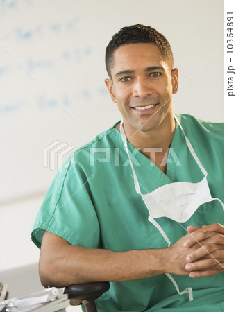 Portrait of male surgeon sitting at desk in hospital Portrait of male surgeon sitting at desk in hospital 10364891