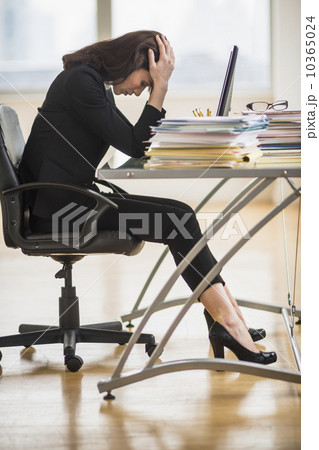 Businesswoman with head in hands 10365024