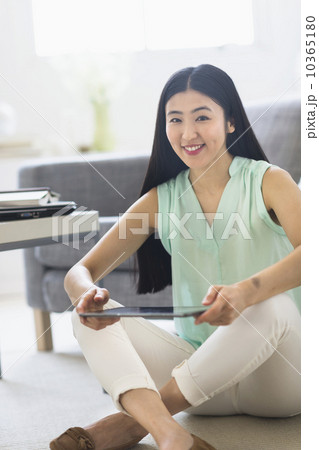 Portrait of woman using tablet pc at home Portrait of woman using tablet pc at home 10365180