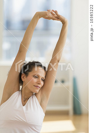 Portrait of woman stretching on exercise ball 10365222