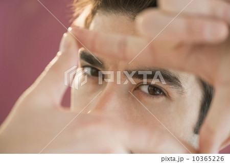 Portrait of man making finger frame 10365226