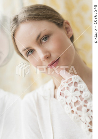 Portrait of blond woman by window 10365548
