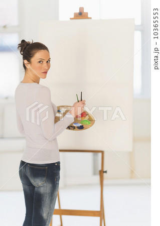 Woman painting at easel 10365553