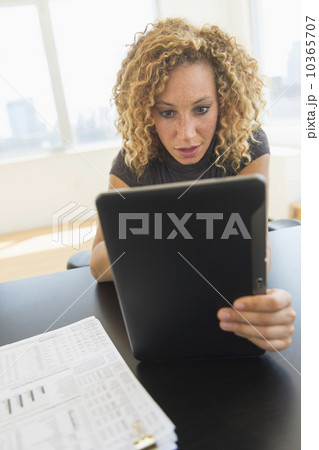 Businesswoman using digital tablet in office 10365707