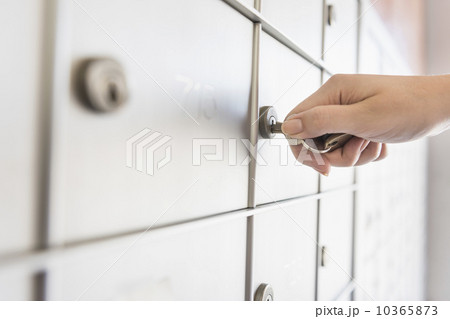 Woman opening safety deposit box 10365873
