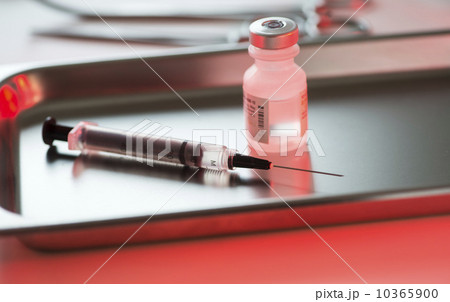 Close up of syringe and medication, studio shot 10365900
