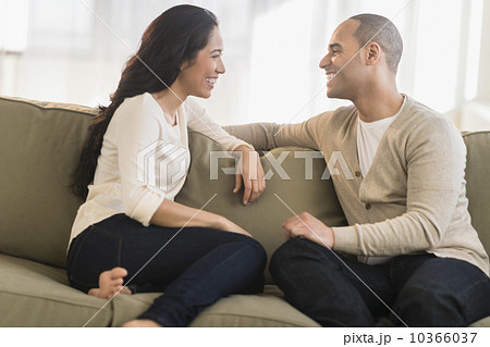 Portrait of young couple sitting on couch Portrait of young couple sitting on couch 10366037