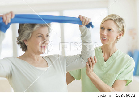 Mature woman exercising with personal trainer 10366072