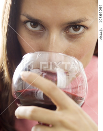 A woman sipping red wine 10366094
