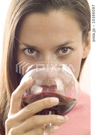 A woman sipping red wine 10366097