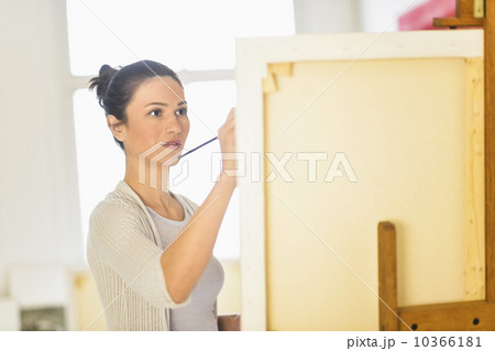 Woman painting at easel 10366181