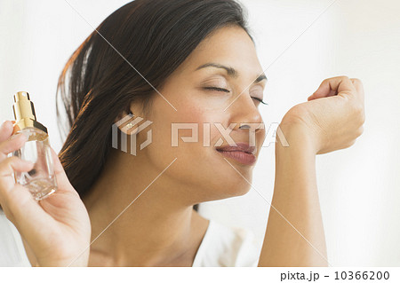 Woman smelling perfume on wrist Woman smelling perfume on wrist 10366200